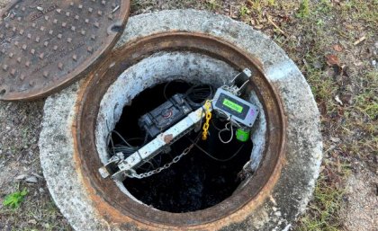 The UQ technology predicts and monitors hydrogen sulphide gas before calculating a precise dose of control chemicals. some wires and tech equipment sits inside a concrete-surrounded hole in the ground
